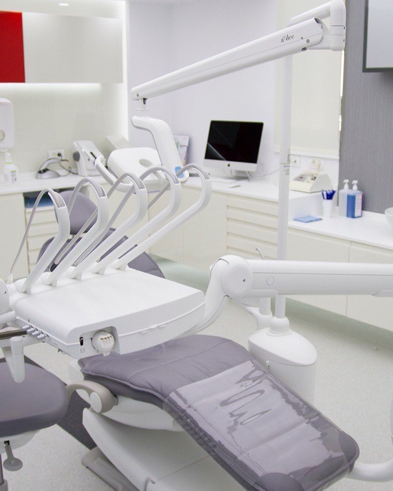 A treatment room at our partner clinic in Bucharest, with an A-dec chair and chairside monitor
