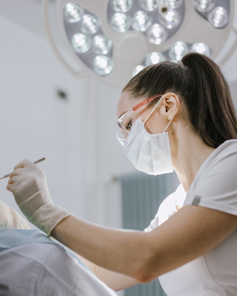 A dentist calmly explaining a treatment plan to a patient